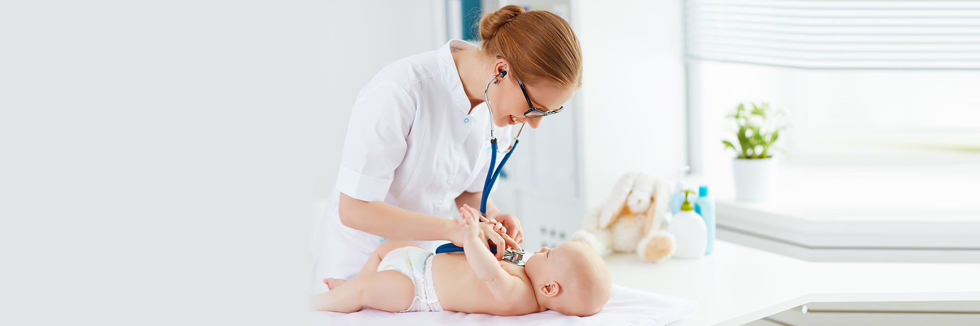 Nurse using Stethoscope on Baby