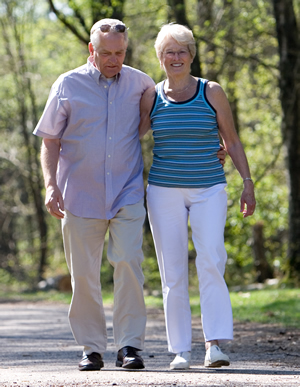 Couple walking along wooded trail