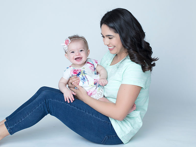 Baby Girl Sitting on Mom's Lap