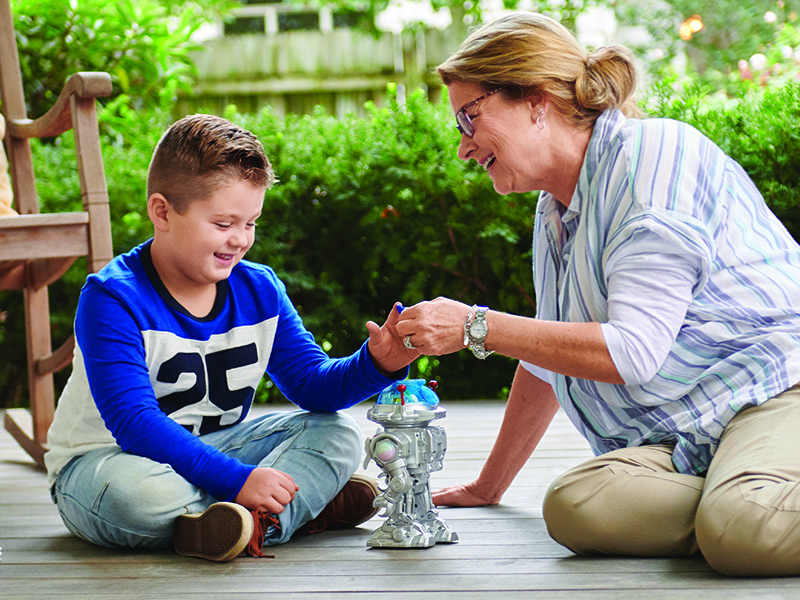 Grandmother playing with grandson on porch