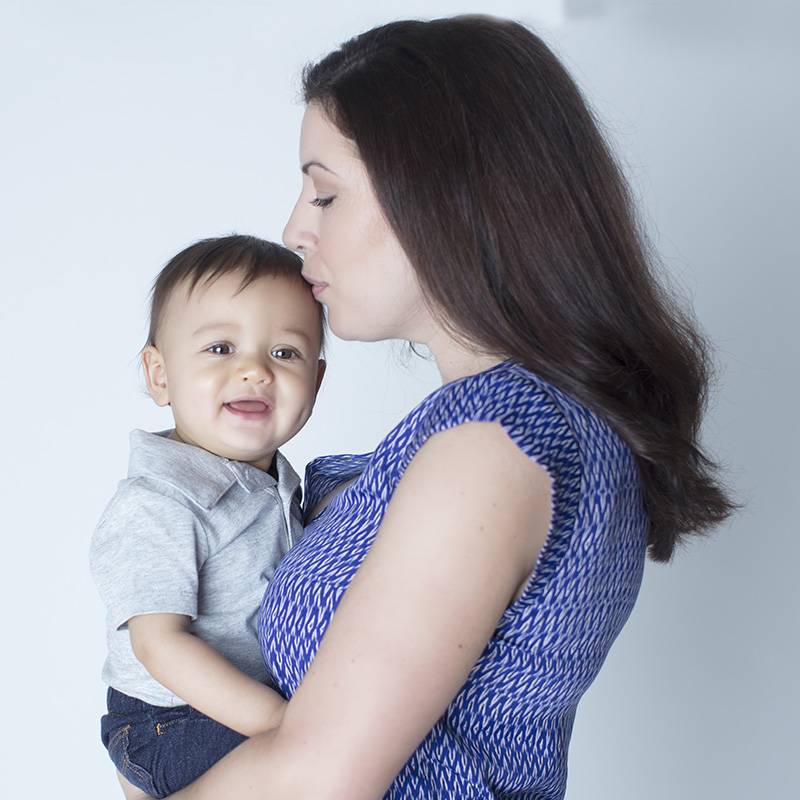 Young Mom Holding Toddler Boy in Her Arms