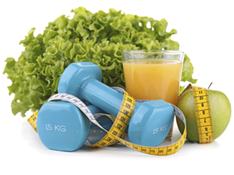 Lettuce, fruit and juice with hand weights on a table