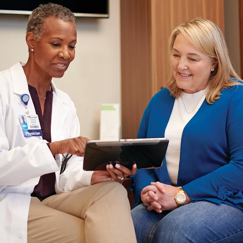 Doctor showing patient tablet